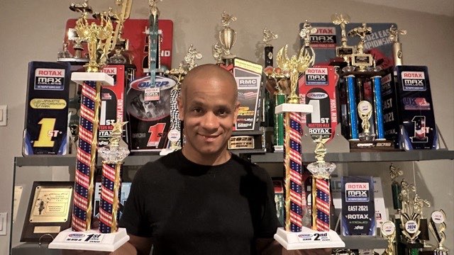 Vince holding 1st and 2nd place trophies